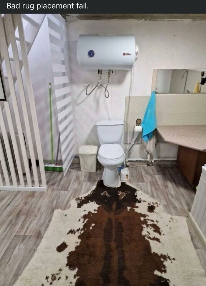 Bathroom with a poorly placed animal print rug in front of the toilet, an example of horrendous DIY craft shaming fails.