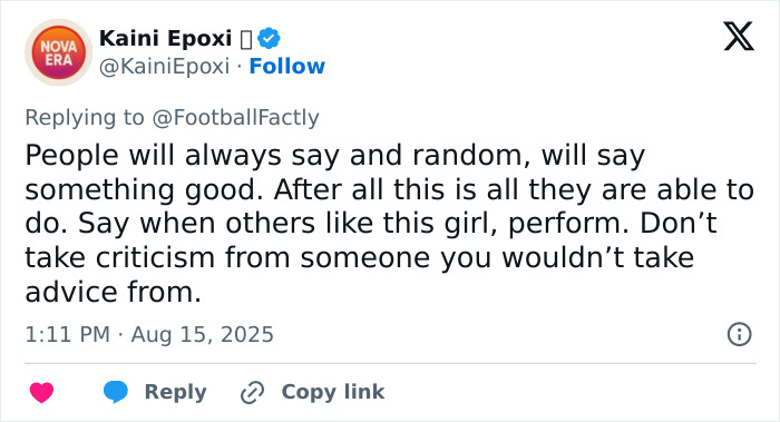 Screenshot of a social media reply defending a soccer team&rsquo;s new signing after trolls criticize her appearance.