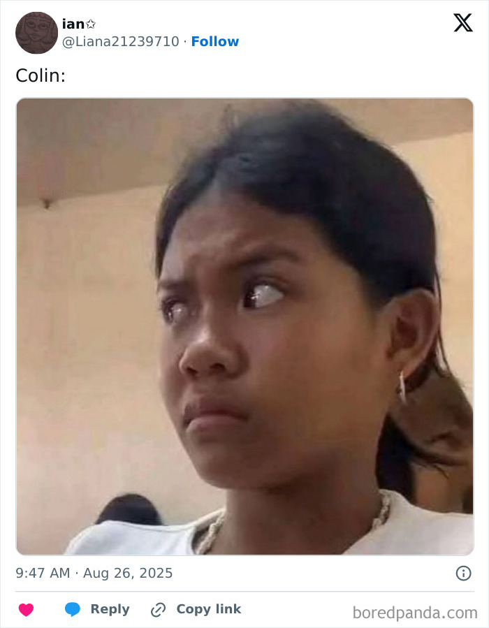 Person with dark hair wearing a white shirt looking sideways with a concerned expression in a plain indoor setting.