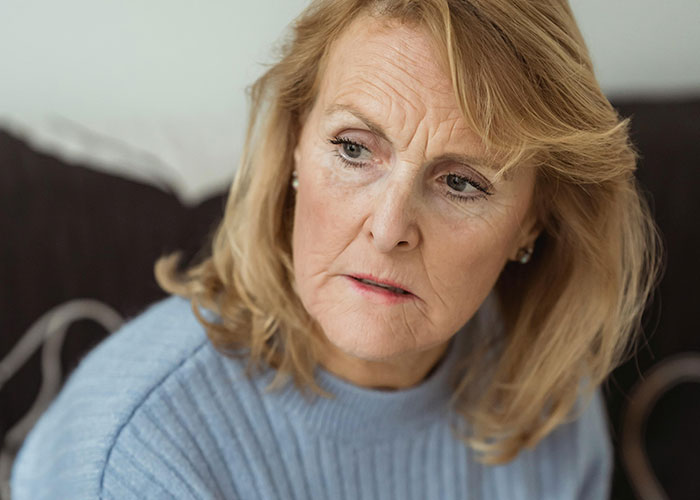 Worried woman with concerned expression avoiding contact, reflecting fear of mother-in-law poisoning affecting pregnancy situation. Worried woman with concerned expression avoiding contact, reflecting fear of mother-in-law poisoning affecting pregnancy situation.