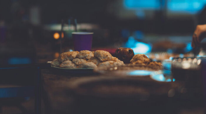 Plate of biscuits on a table with blurred background, illustrating the moral dilemma poll concept for reflection.