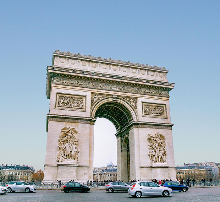 Arc de Triomphe in Paris with traffic, near the Tomb of Unknown Soldier where a man was arrested lighting a cigarette. - 1