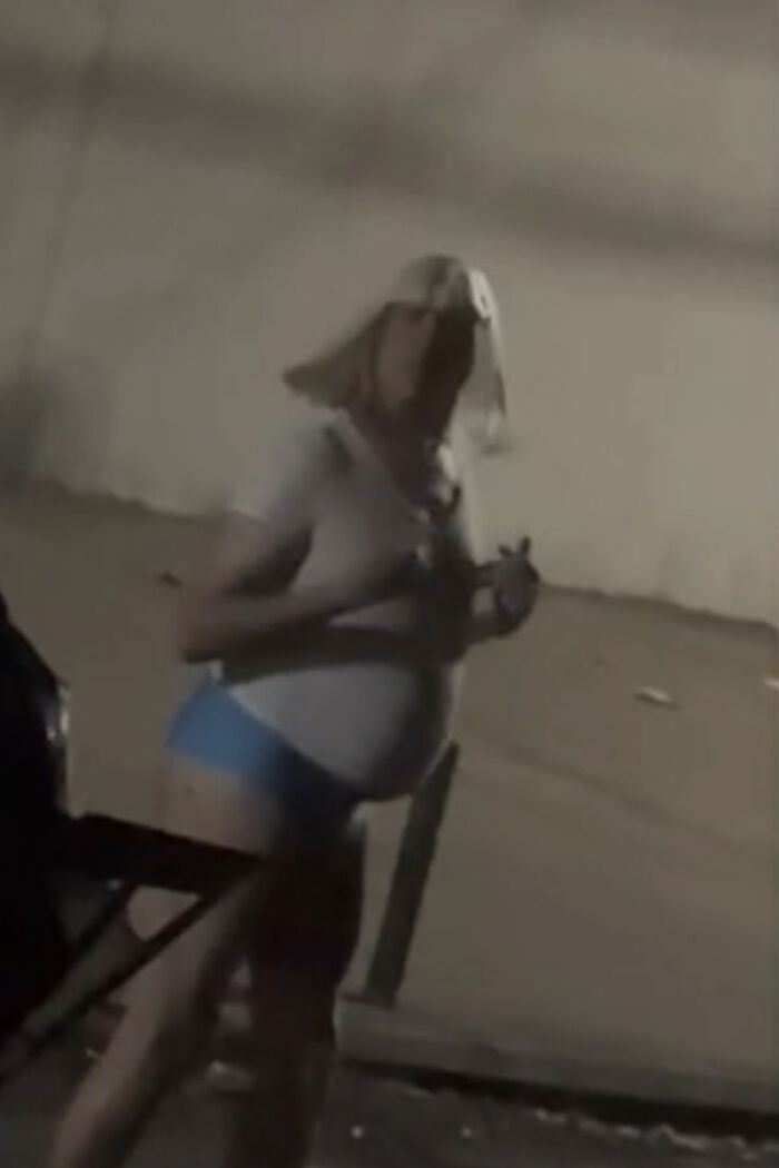 Person wearing a thong and wig standing outdoors at night, related to pastor caught undercover meme controversy. Person wearing a thong and wig standing outdoors at night, related to pastor caught undercover meme controversy.