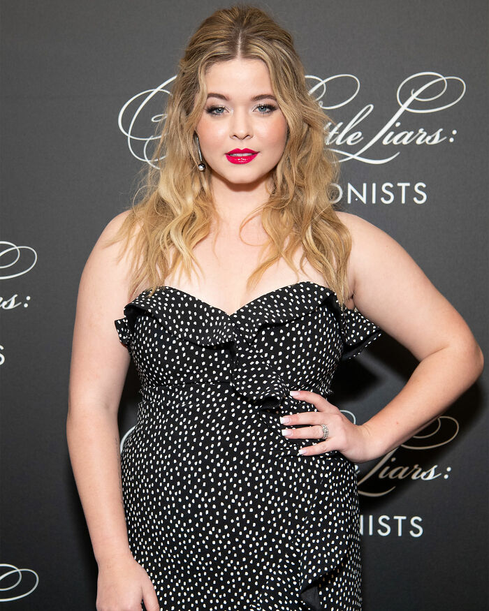 Sasha Pieterse wearing a black and white polka dot dress at an event, addressing 70-pound weight gain and doctors' blame.