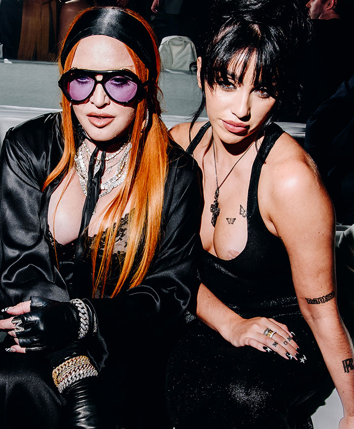 Madonna and her daughter Lourdes at a party, with Lourdes wearing a revealing black outfit causing a nip slip.
