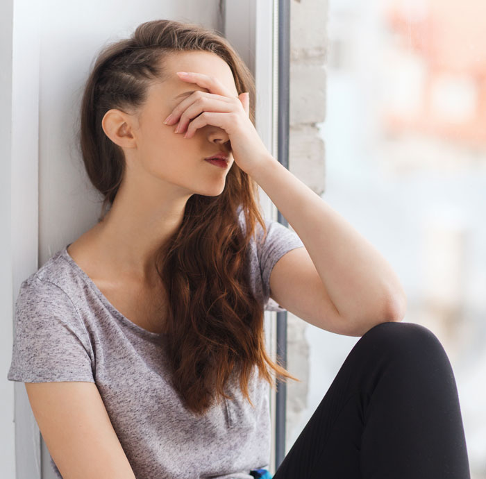 Woman sitting by a window looking frustrated as man tells wife she couldn&rsquo;t do it without him, watching her prove him wrong