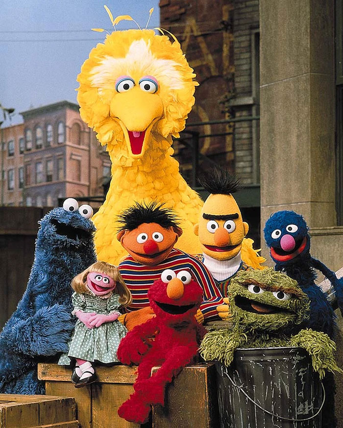 Group of colorful Sesame Street characters posing together, showcasing a fun and iconic family flex moment.