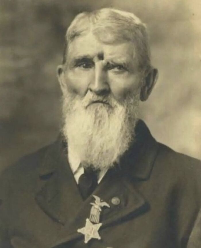 Sepia-toned portrait of an elderly man with a long white beard wearing a formal coat and medal, unsettling morbid knowledge image.