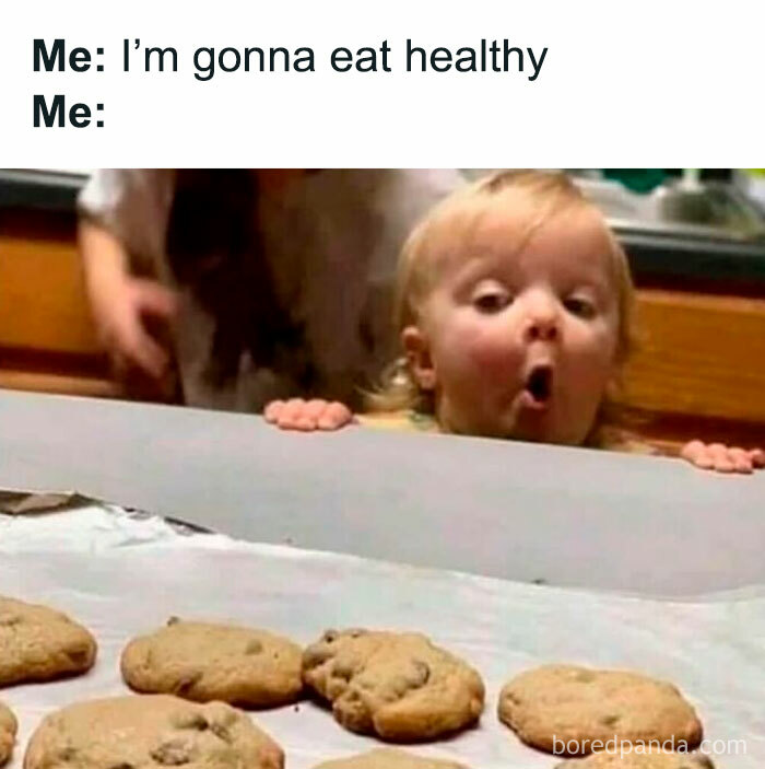 Toddler looking excitedly at chocolate chip cookies on a tray, representing introvert-worthy memes about food cravings.