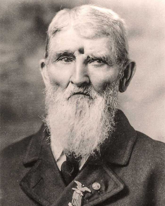 Portrait of an elderly man with a long white beard, showcasing unfamiliar parts of history in a vintage black and white photo.