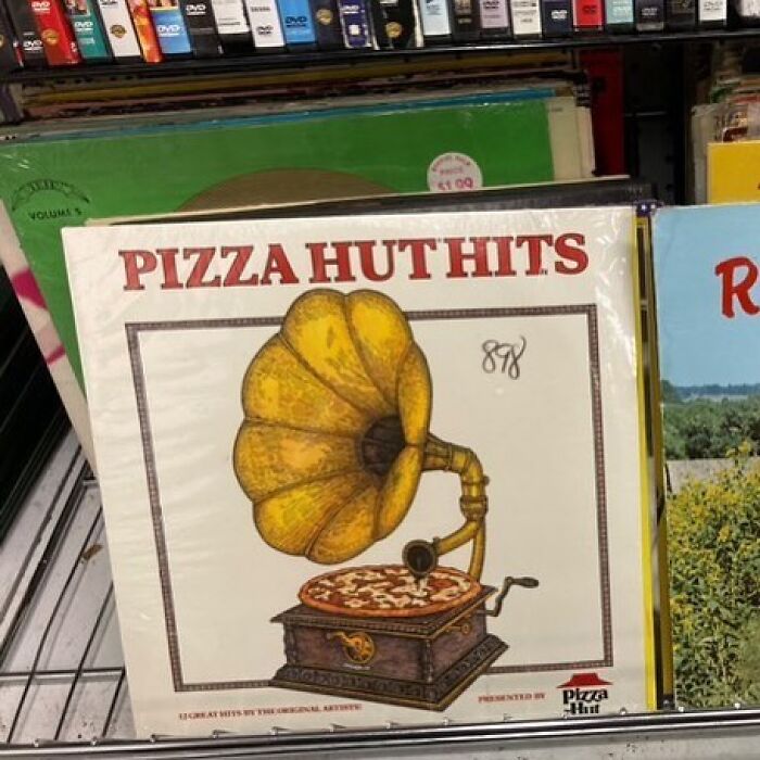 Vinyl record titled Pizza Hut Hits featuring a gramophone with a pizza as the record found at a thrift store.