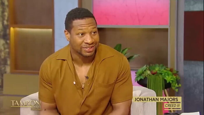 Actor Jonathan Majors, featured in a talk show setting, discussed his career as a celebrity Hollywood tried to make leading A-lister.