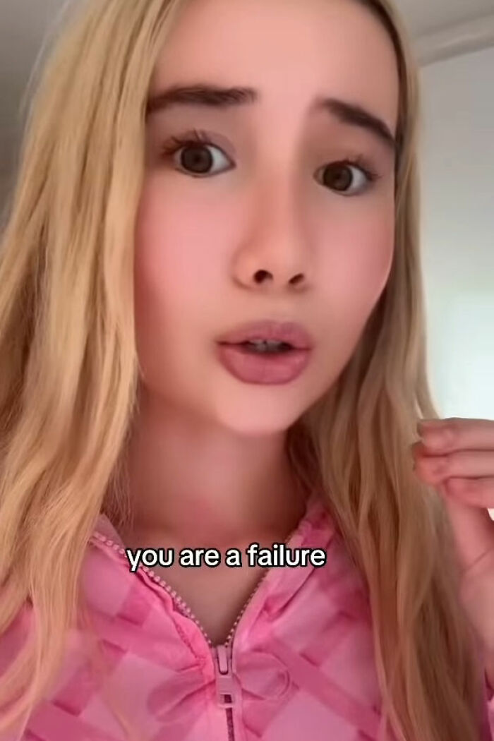 Young adult star with long blonde hair and pink hoodie discussing women who work 9 to 5 and OnlyFans success. Young adult star with long blonde hair and pink hoodie discussing women who work 9 to 5 and OnlyFans success.