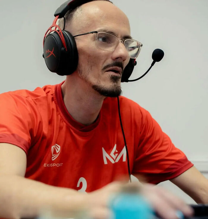 Streamer wearing headset and glasses intensely focused while gaming, highlighting famous streamer passing away live on air. Streamer wearing headset and glasses intensely focused while gaming, highlighting famous streamer passing away live on air.