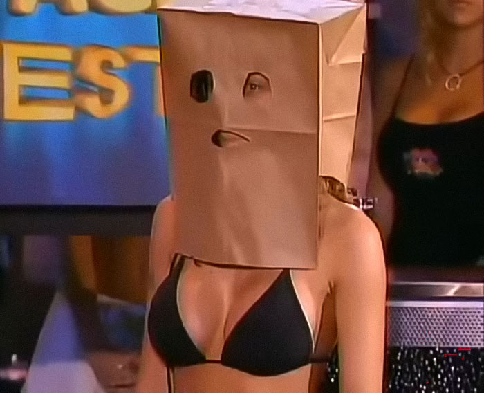 Woman in black bikini wearing paper bag mask, related to outrage over Miss Buttaface and Zendaya comparison. Woman in black bikini wearing paper bag mask, related to outrage over Miss Buttaface and Zendaya comparison.