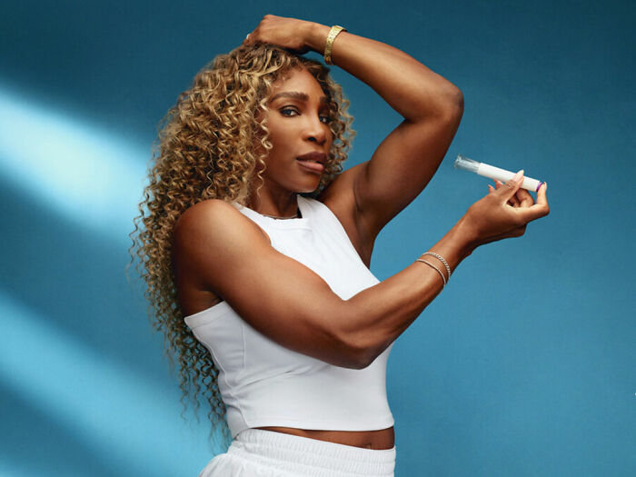 Serena Williams holding a weight loss injection, showing toned arms and curly hair against a blue background.