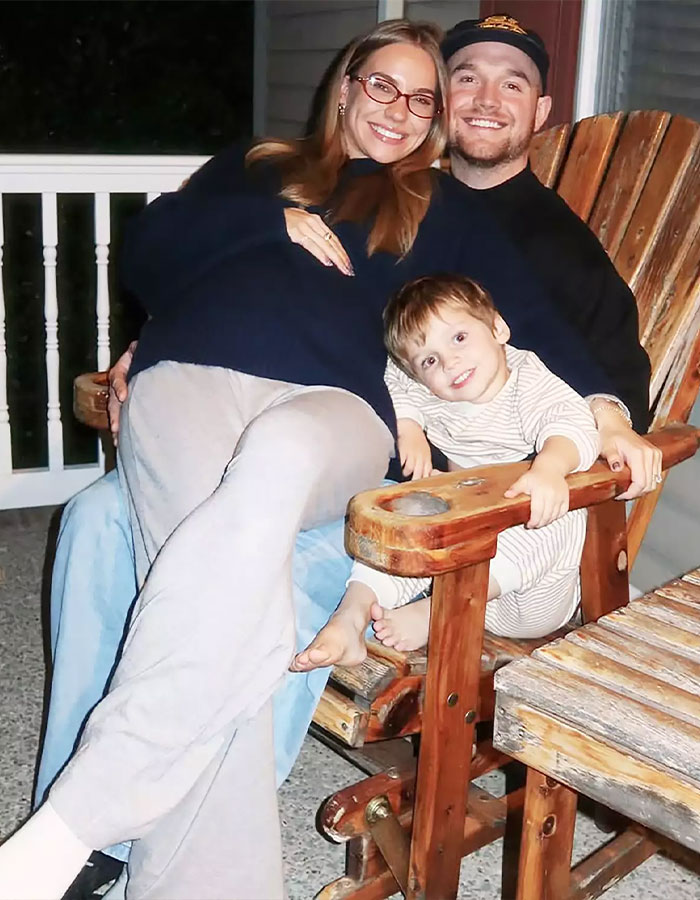 A smiling family sitting on wooden chairs, representing momfluencer taking full accountability after tragic drowning in home pool.