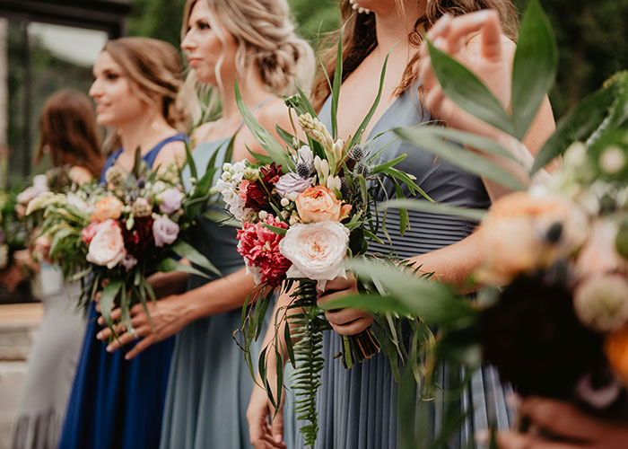 Bridesmaids holding floral bouquets at a wedding, illustrating family treating wedding as a convenient celebration time.