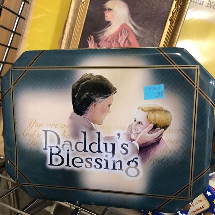 Vintage Daddy's Blessing sign with a father and child illustration found among bizarre thrift store items.