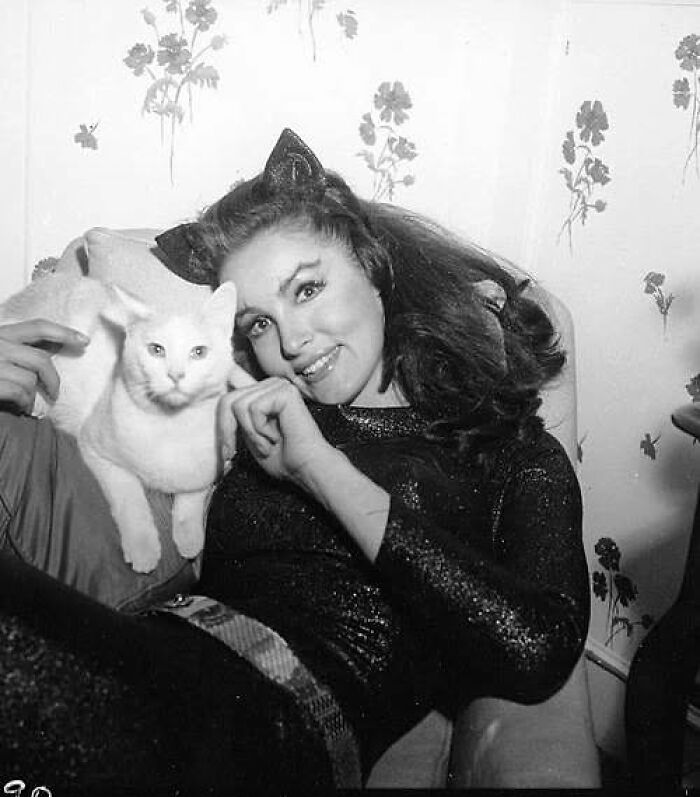 Vintage cat photo of a woman with cat ears posing with a white cat, showcasing classic charm and internet gold appeal.