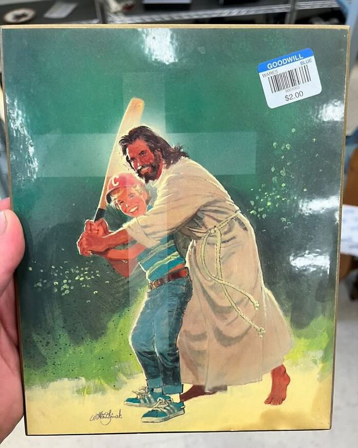 Illustration of Jesus helping a boy hold a baseball bat, unusual thrift store find with a $2 price tag visible.
