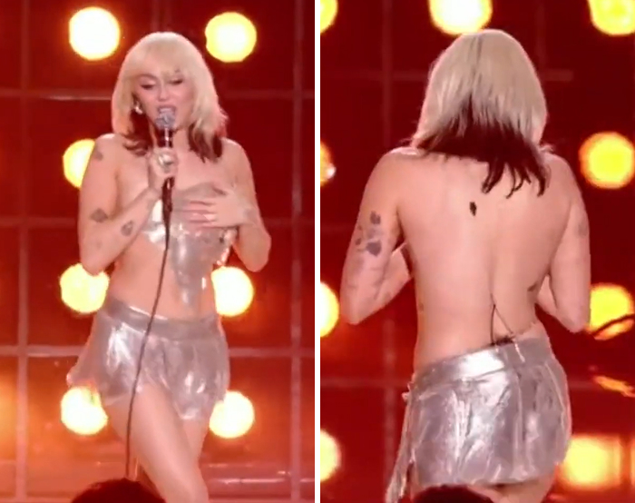 Celebrity wardrobe malfunction on stage with silver metallic outfit and fans reacting to unexpected moments under bright lights.