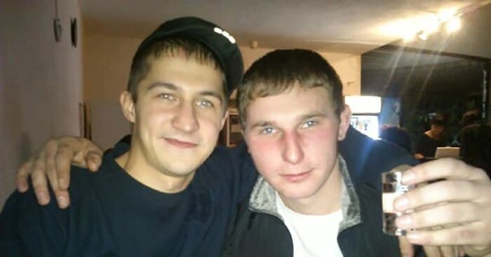 Two young men posing closely indoors, one holding a glass, an example of unsettling images from Morbid Knowledge group.