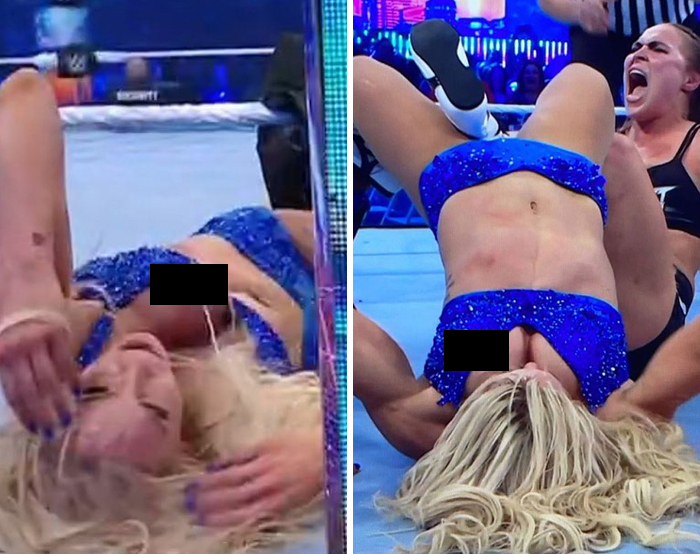 Female wrestler experiencing a celebrity wardrobe malfunction in a blue outfit during a live wrestling match.