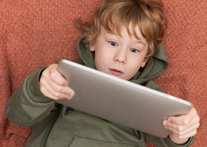 Child with curly hair enjoying a colorful ice cream cone, illustrating funny lies parents tell their kids about treats.