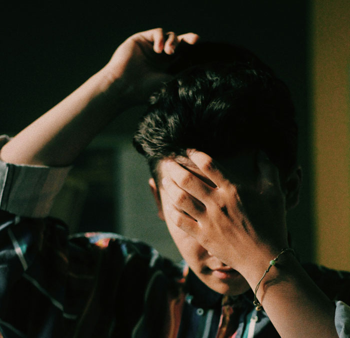 Young guy showing frustration and stress, refusing to babysit siblings after feeling treated like a stranger for years. Young guy showing frustration and stress, refusing to babysit siblings after feeling treated like a stranger for years.