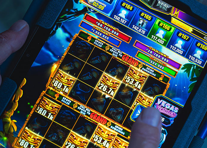 Person playing a casino slot game on a tablet, illustrating jobs that only a person without a soul would do