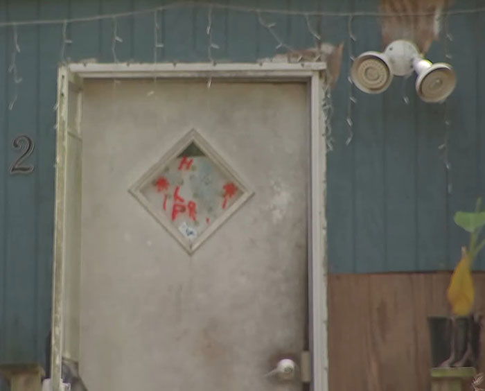 Old weathered door of a Florida home where mother abandoned her child and seven dogs during vacation.
