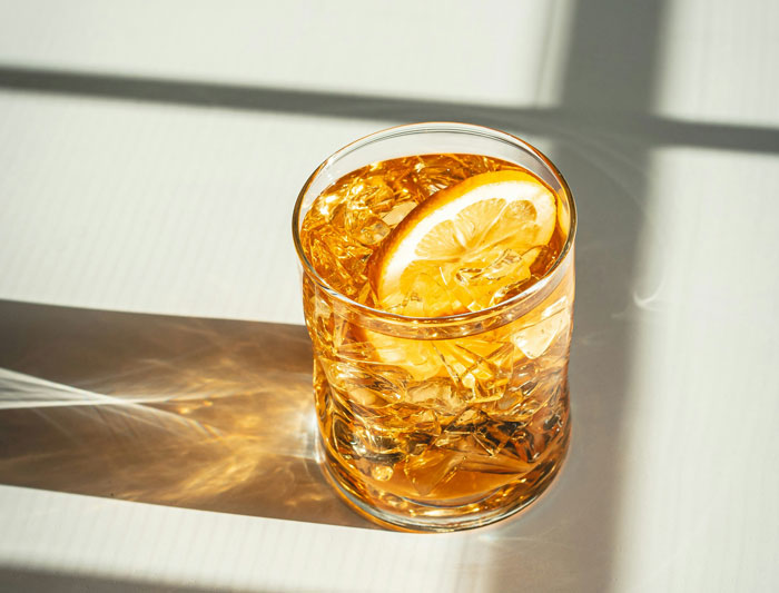 Glass of iced drink with lemon slice representing bar staff and customers protecting women from creeped out men stories