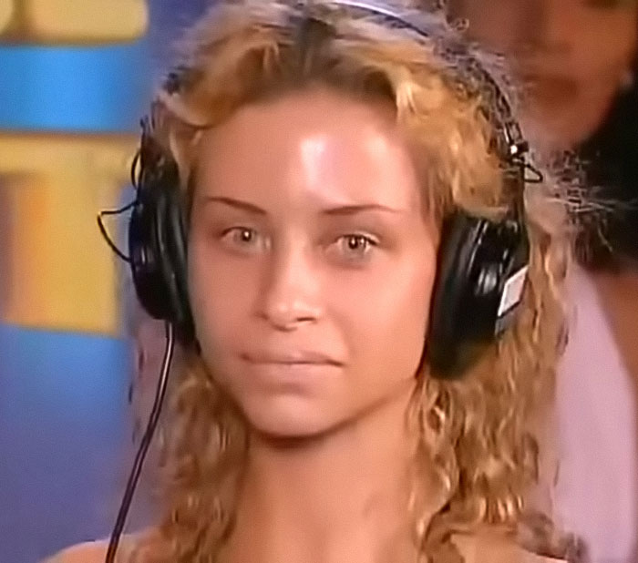 Young woman with curly hair wearing large black headphones during a contest related to early 2000s ugliest woman comparisons. Young woman with curly hair wearing large black headphones during a contest related to early 2000s ugliest woman comparisons.