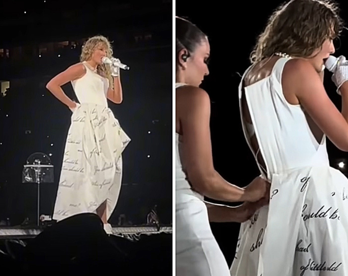 Singer on stage wearing a white dress with text print, assisted backstage to fix a celebrity wardrobe malfunction moment.