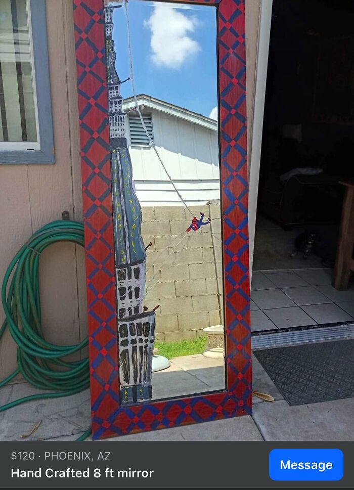 Handcrafted 8 ft mirror with a painted cityscape and Spider-Man, showcasing a horrendous DIY craft shaming project.
