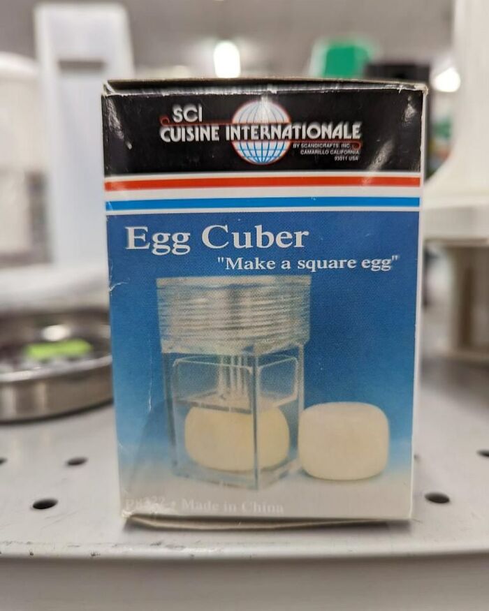 Boxed kitchen gadget called Egg Cuber that shapes eggs into squares, a bizarre thrift store find on a store shelf.