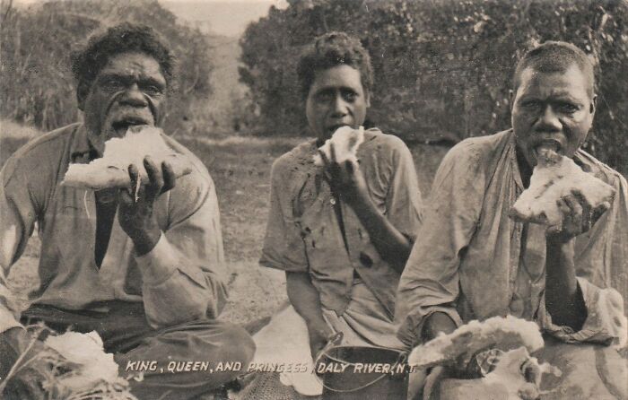 Three Indigenous Australians from the 1900s eating traditional food, offering rare glimpses into historical Indigenous life.