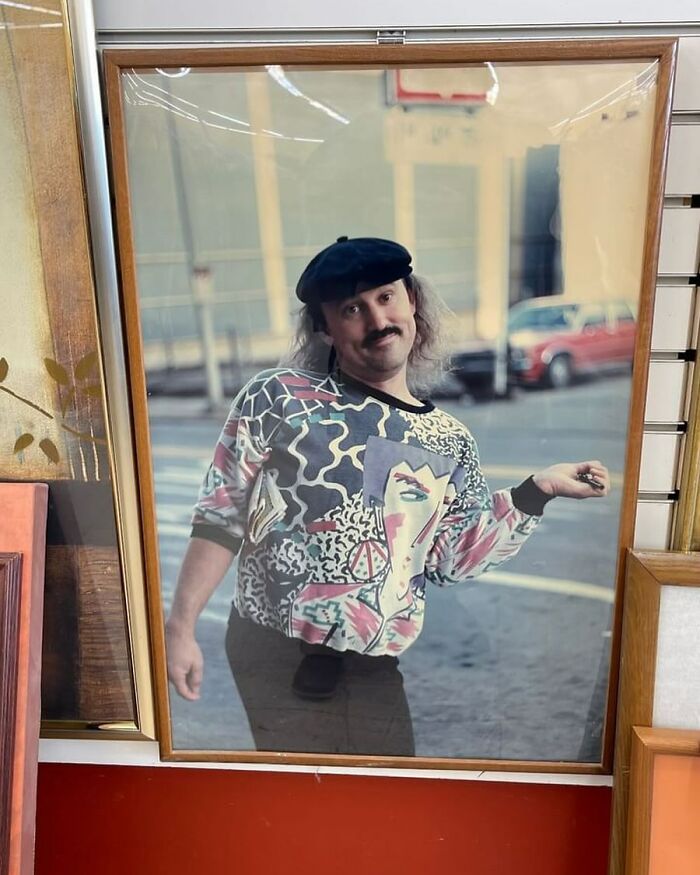 Framed photo found at a thrift store showing a man in a colorful abstract patterned shirt and black beret posing humorously.