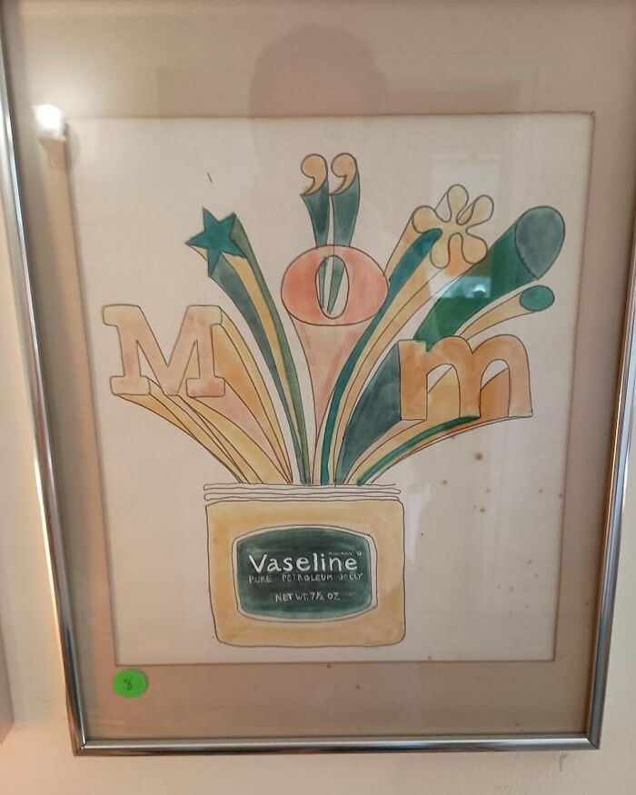 Framed artwork showing a Vaseline jar with colorful abstract shapes and letters spelling mom, found at thrift stores.