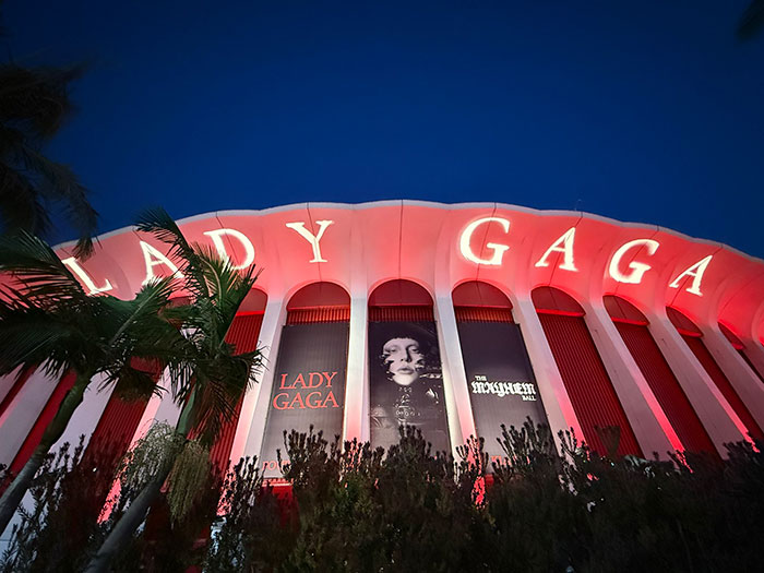 Lady Gaga concert venue lit up at night with large signage amid backlash over ageist and misogynistic comments. - 9