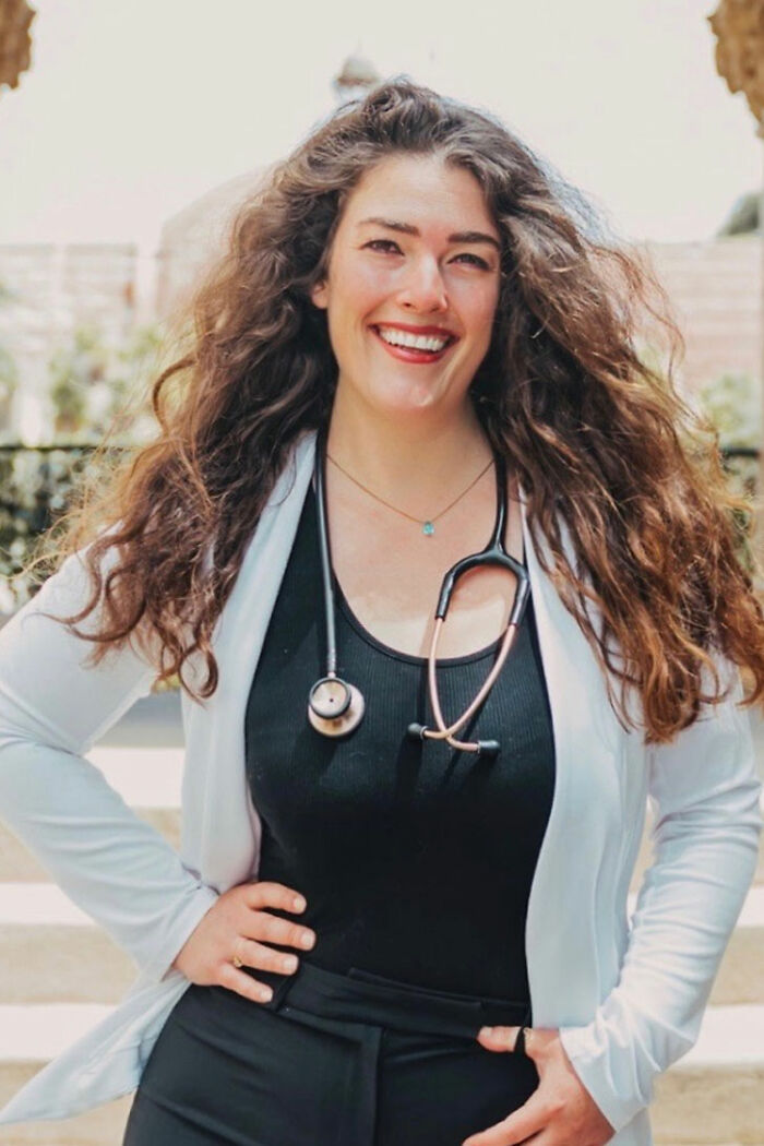 Female doctor with stethoscope smiling outdoors, representing habit tips to help prevent heart attack and dementia.