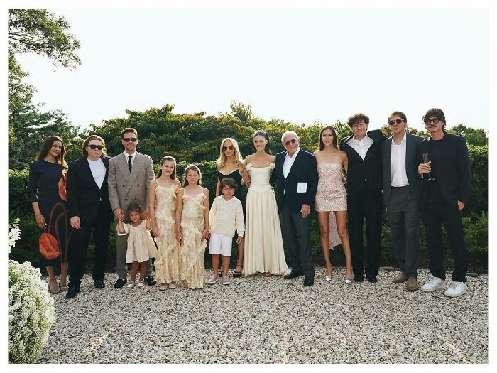 David and Victoria Beckham with family outdoors, reflecting emotions over Brooklyn's vow renewal speech at an elegant event.