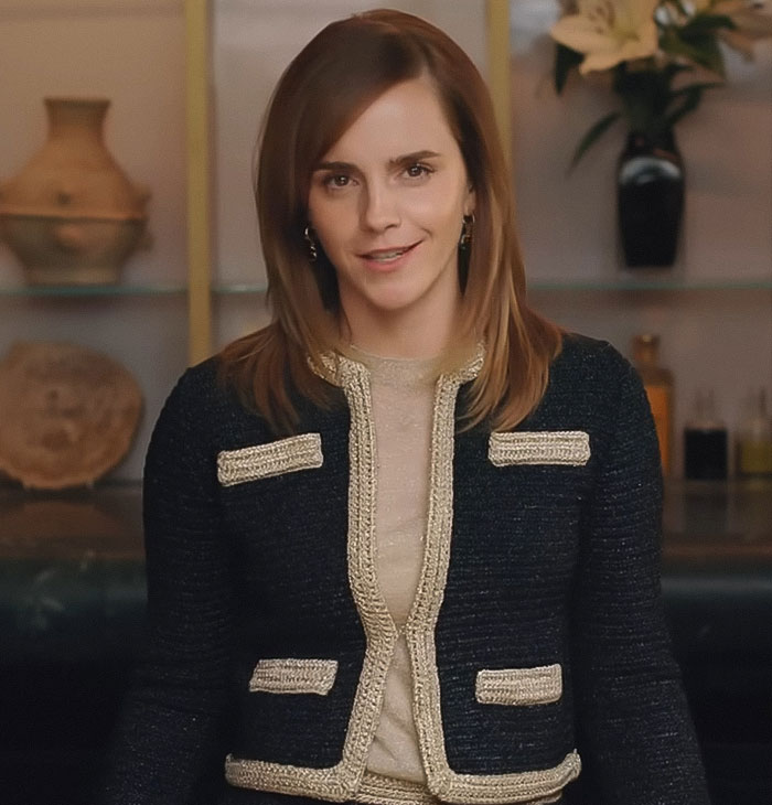 Emma Watson wearing a stylish outfit indoors, posing confidently with a natural background and subtle smile.