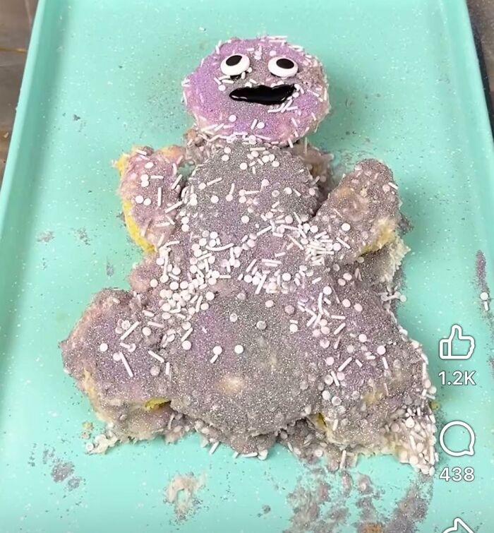 Failed DIY craft project shaped like a person, covered in glitter and white sprinkles on a turquoise tray.