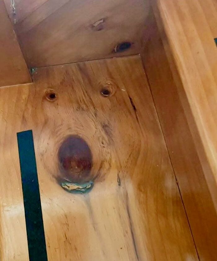 Wooden surface with random objects resembling a face with eyes, nose, and mouth, showcasing face-like patterns.
