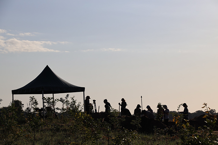 Archaeologists working at a pyramid site in Poland during sunset, exploring structures older than Egypt pyramids. Archaeologists working at a pyramid site in Poland during sunset, exploring structures older than Egypt pyramids.