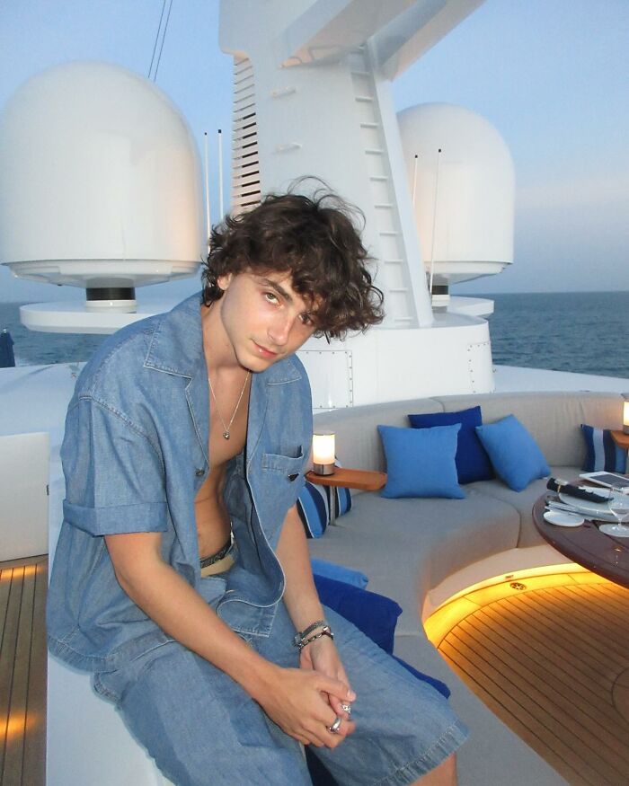 Timoth&eacute;e Chalamet sitting on a yacht deck wearing denim, sharing a bizarre post on Kylie Jenner&rsquo;s birthday.