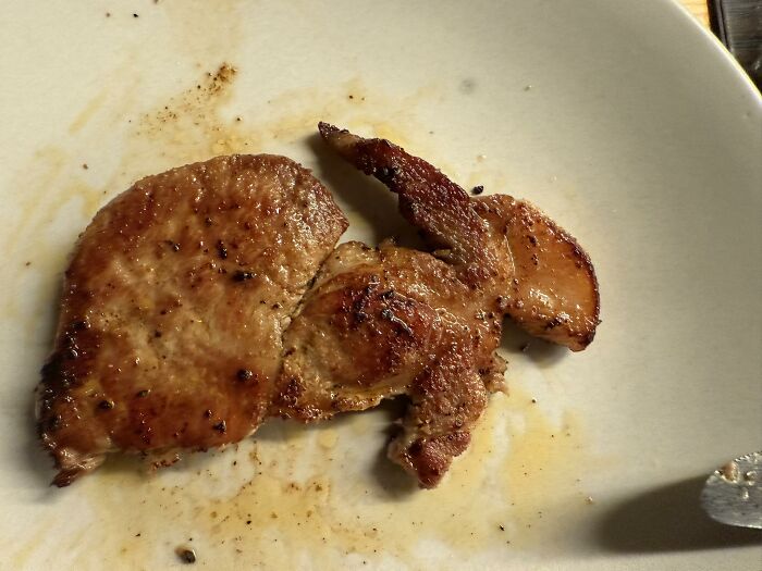 Grilled meat on a plate resembling a face, illustrating random objects that look like faces shared in a Facebook group.