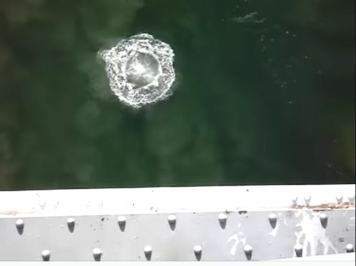 Aerial view of water splashing below a bridge, one of the 54 pics any man would be excited to see online.